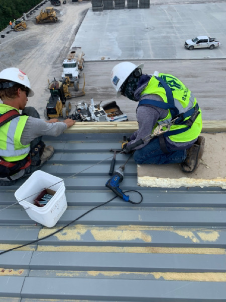 commercial roofers working on an industrial roof repair