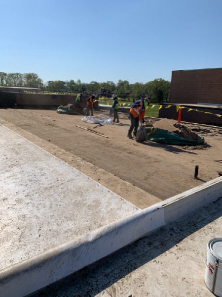 commercial roofers working on a flat roof.